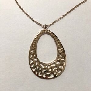 Gold Tone Egg-Shaped Pendant Necklace With Cut-Out Details